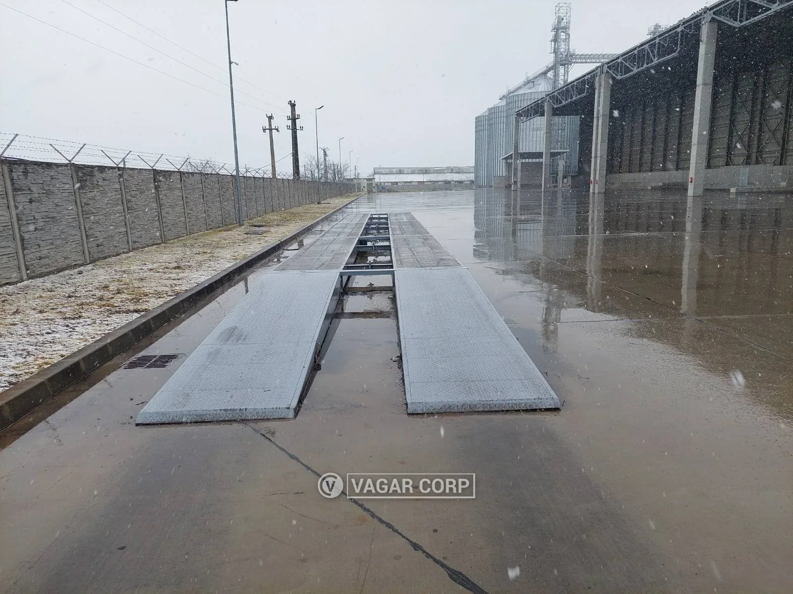 Čelična kamionska vaga na platou pod snegom, ispred hale za skladištenje